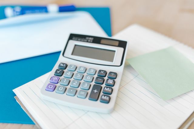 a calculator and papers on a desk